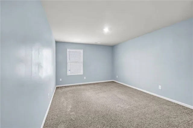 a view of an empty room and a window