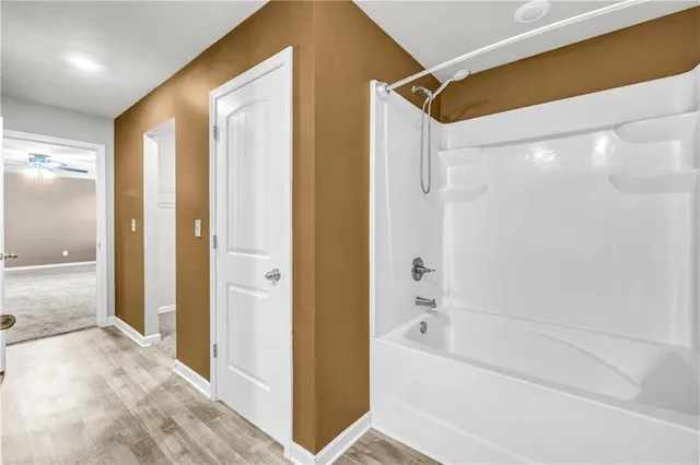 a bathroom with a bathtub and a shower