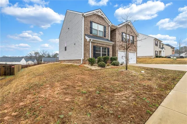 a front view of a house with a yard