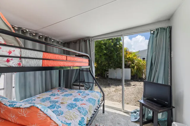 a bedroom with furniture and large windows