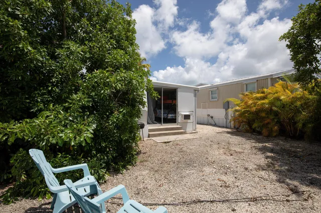 a backyard of a house with table and chairs