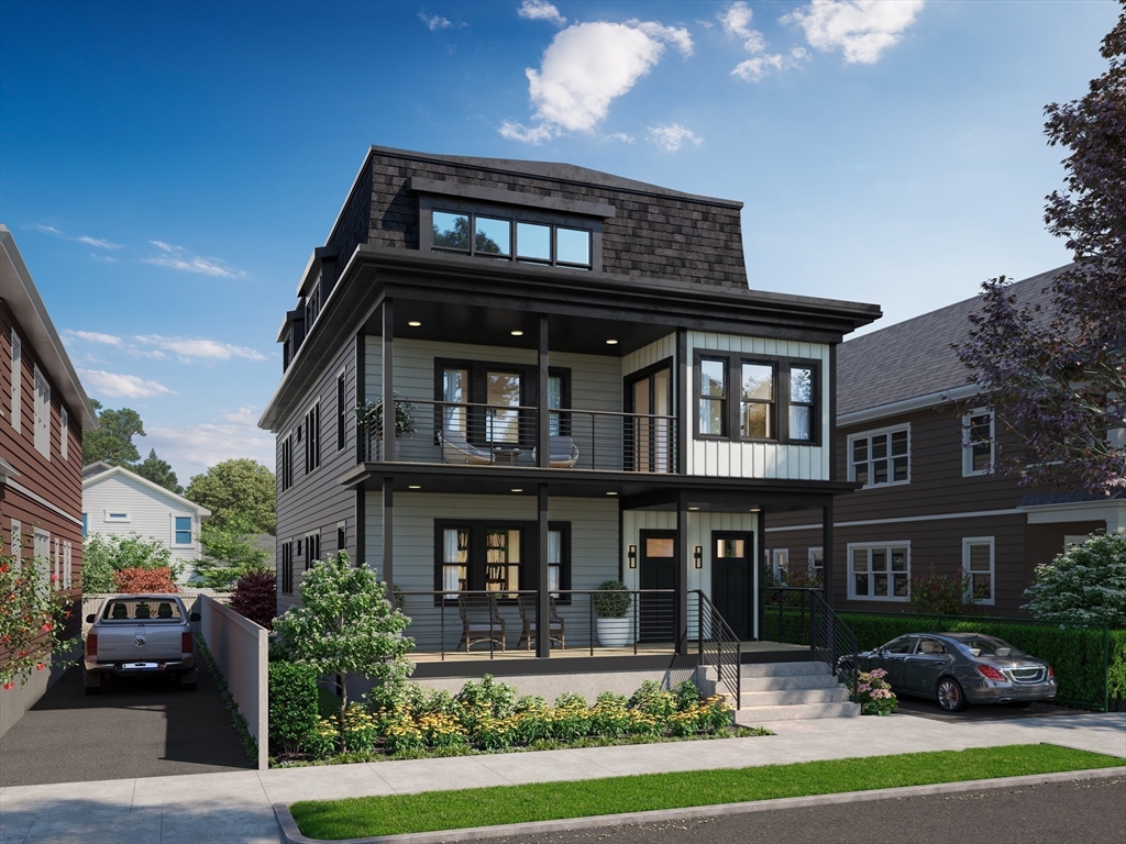 a front view of a residential apartment building with a yard