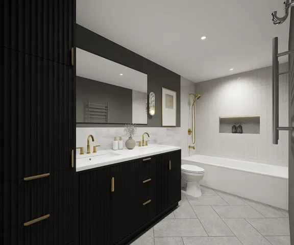 a bathroom with a double vanity sink a toilet and a bathtub