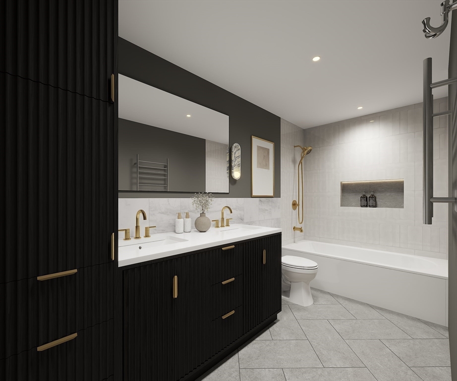 34 Governor Winthrop Road, Unit 2 Somerville, MA 02145 - Photo 11 of 23 a bathroom with a double vanity sink a toilet and a bathtub