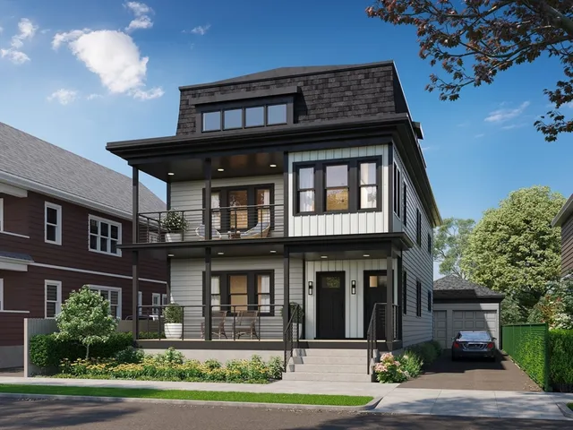 a front view of a residential apartment building with a yard