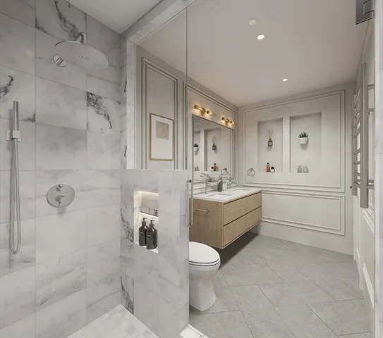 a bathroom with a double vanity sink toilet and shower