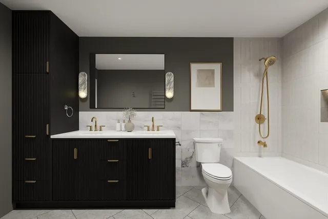 a bathroom with a toilet sink double vanity and mirror