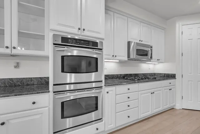 a kitchen with granite countertop a refrigerator and a sink