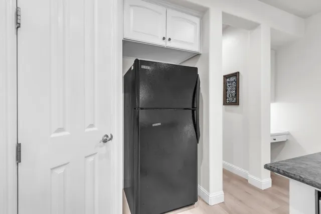 a spacious bathroom with a granite countertop sink mirror and a bathtub