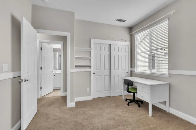 a view of an empty room and a ceiling fan