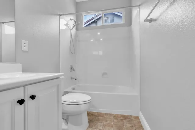 a bedroom with a bed and a ceiling fan