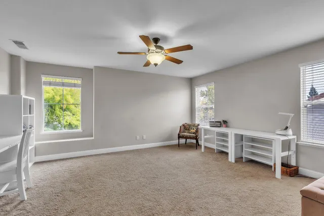 a view of a house with backyard and a tree