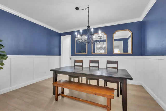 a room with pool table and windows