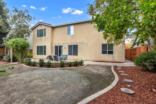 an aerial view of a house with a yard and garden