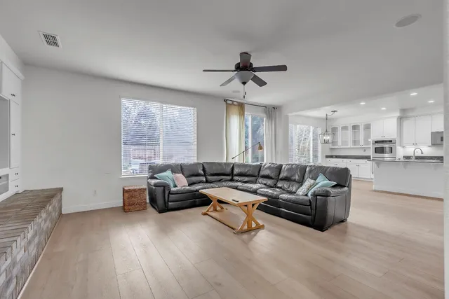 a kitchen with granite countertop white cabinets and stainless steel appliances