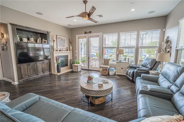 a living room with furniture and paintings on the wall