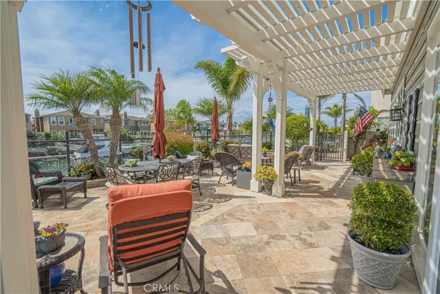 an aerial view of a city with lots of residential buildings ocean and mountain view in back