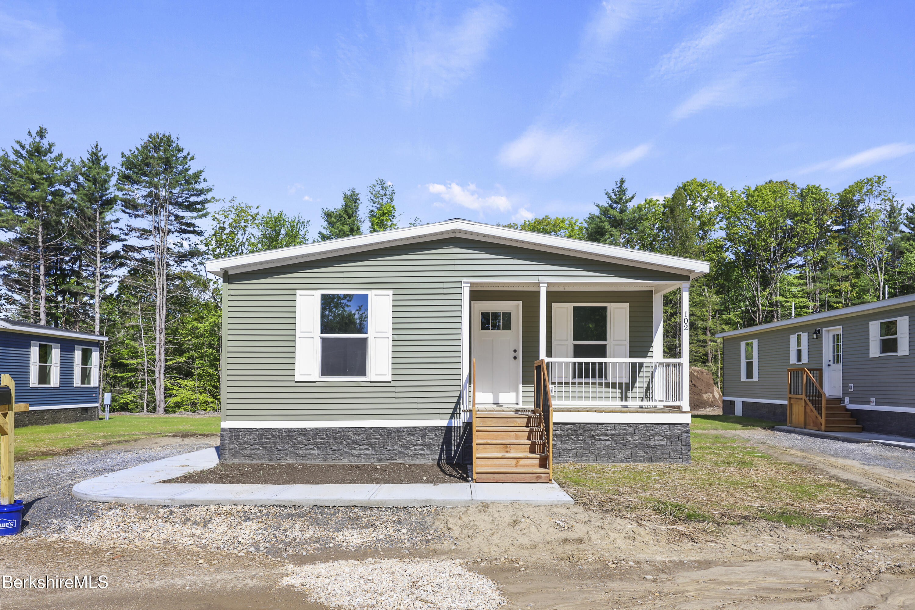 395 Cheshire Road, Unit 102 Pittsfield, MA 01201 - Photo 1 of 28 a front view of a house with garden