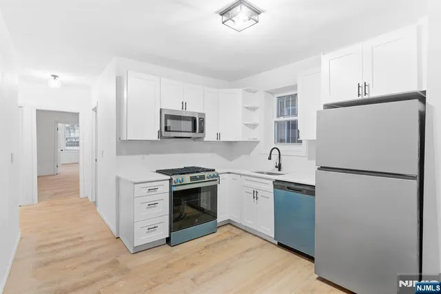 an empty room with a empty space and windows