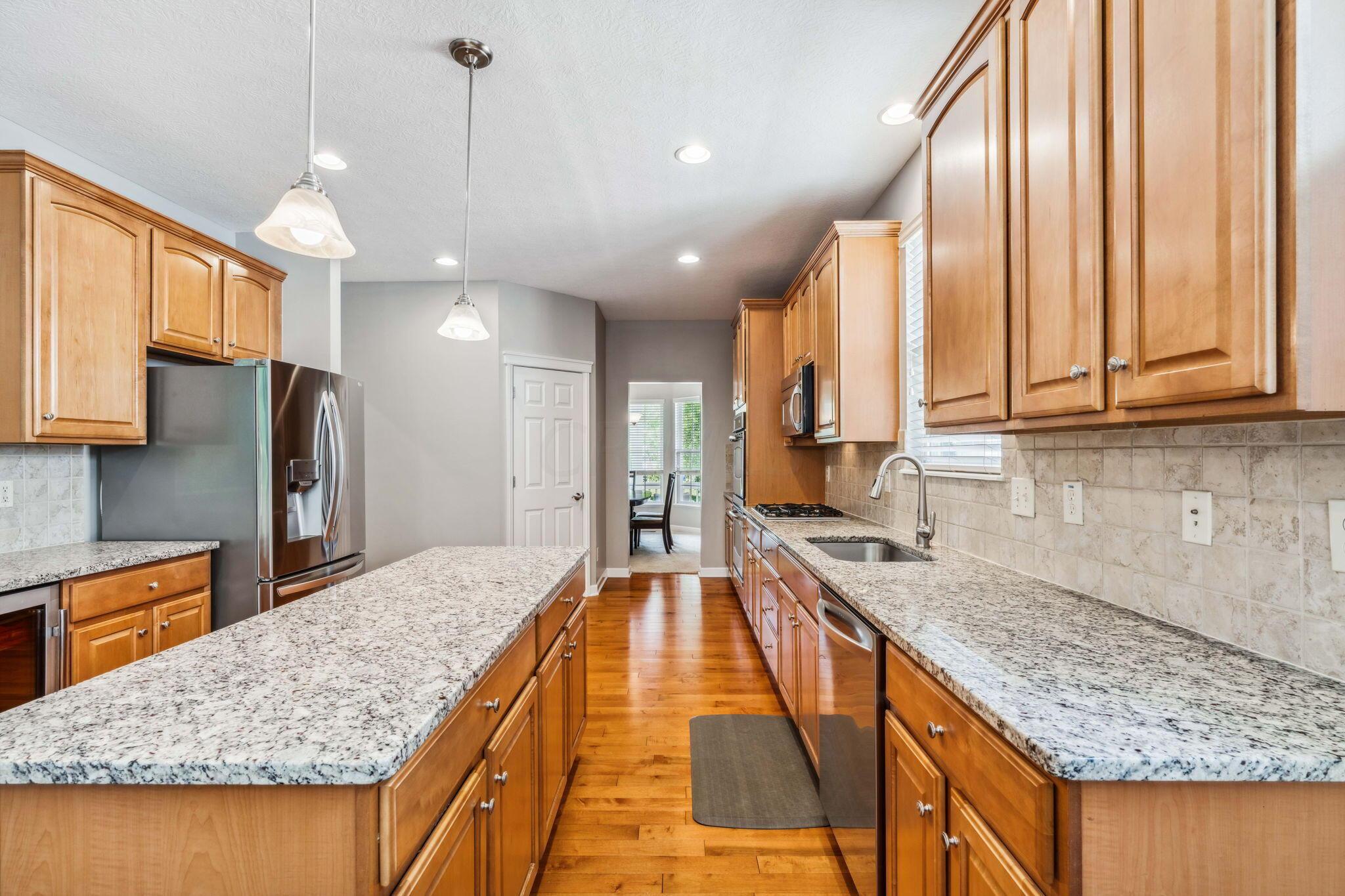 219 Smokewood Road Powell, OH 43065 - Photo 13 of 59 Granite countertops, island, walk-in pantry, single basin sink, gas top range, double wall ovens and built-in wine fridge!