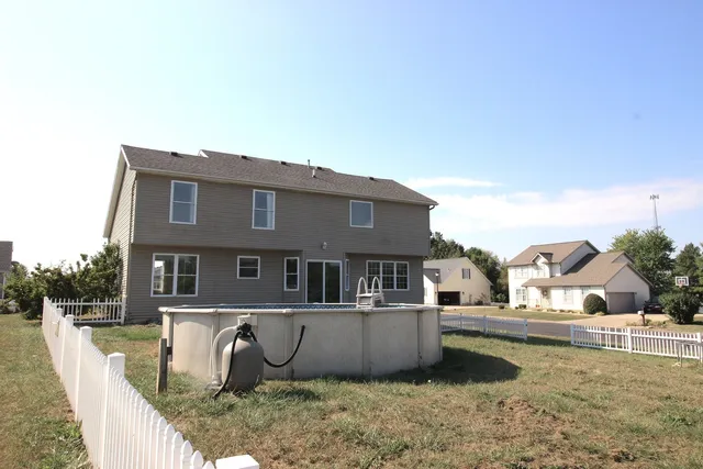 a view of a house with backyard porch and sitting area