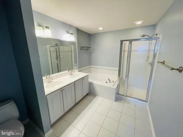 a bathroom with a tub a sink and a shower