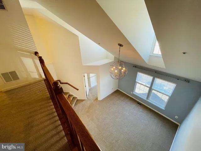 an empty room with a empty space and windows