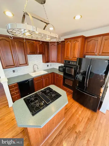 a kitchen with granite countertop a stove and a sink