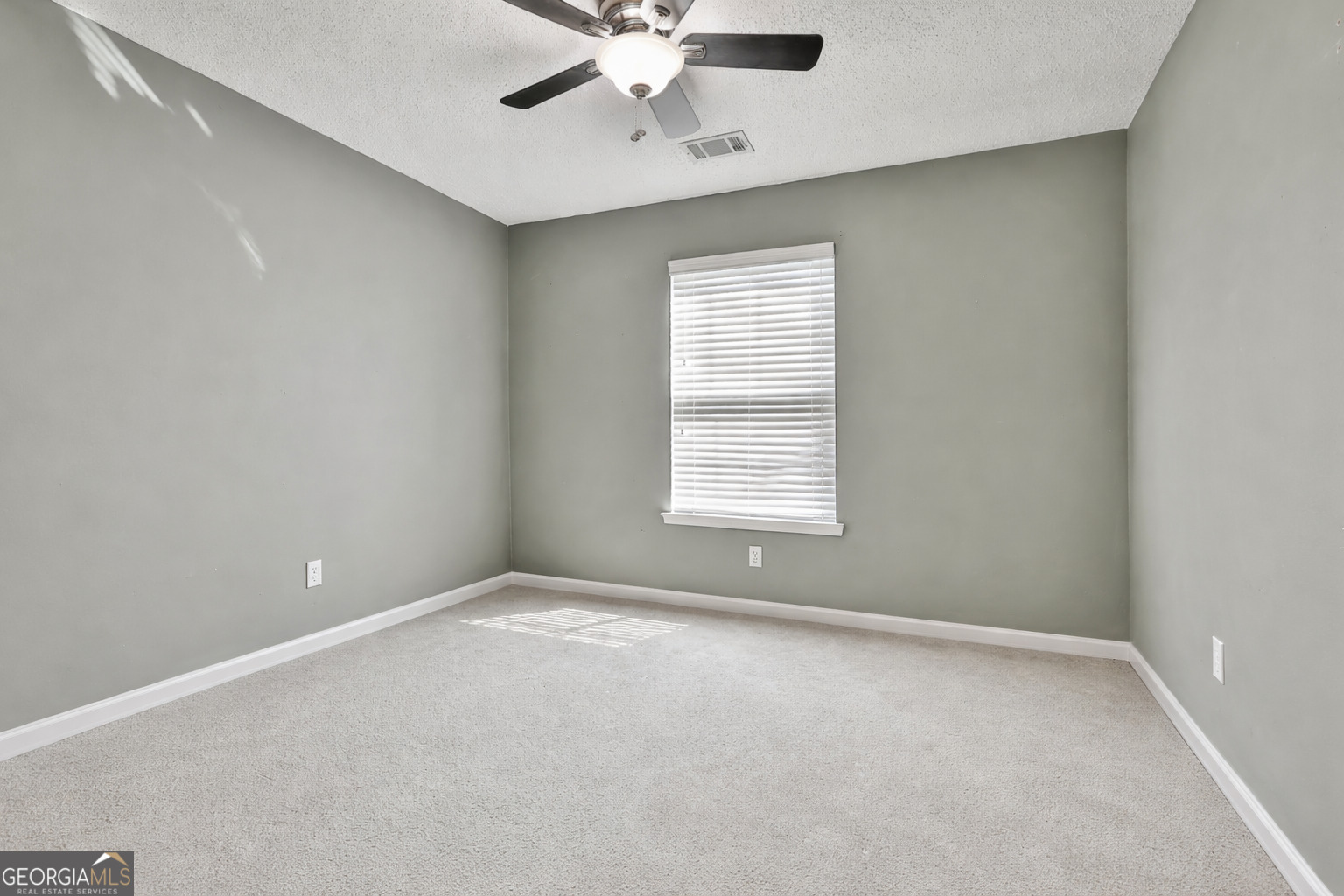 7759 Bucknell Terrace Fairburn, GA 30213 - Photo 17 of 26 an empty room with a window and a fan