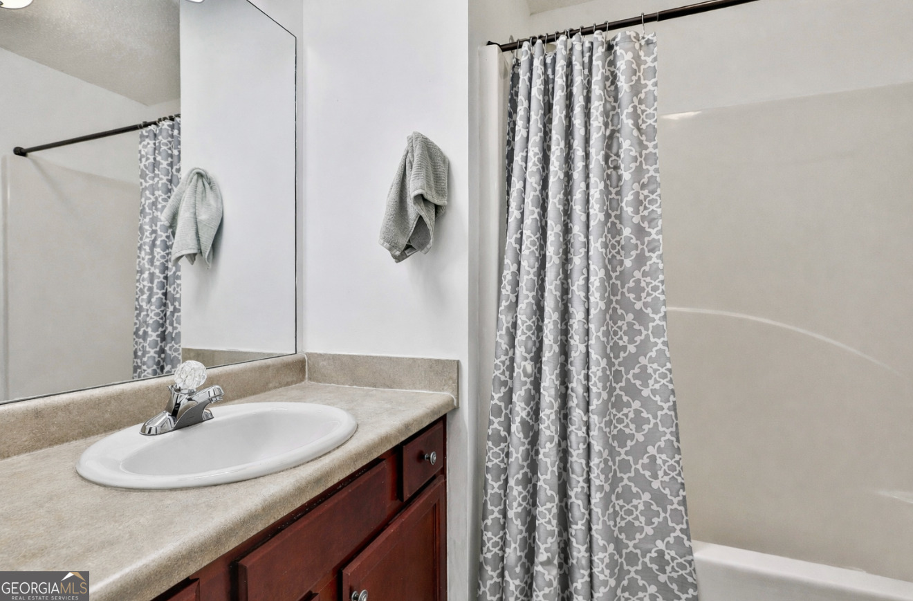7759 Bucknell Terrace Fairburn, GA 30213 - Photo 19 of 26 a bathroom with a sink and a mirror