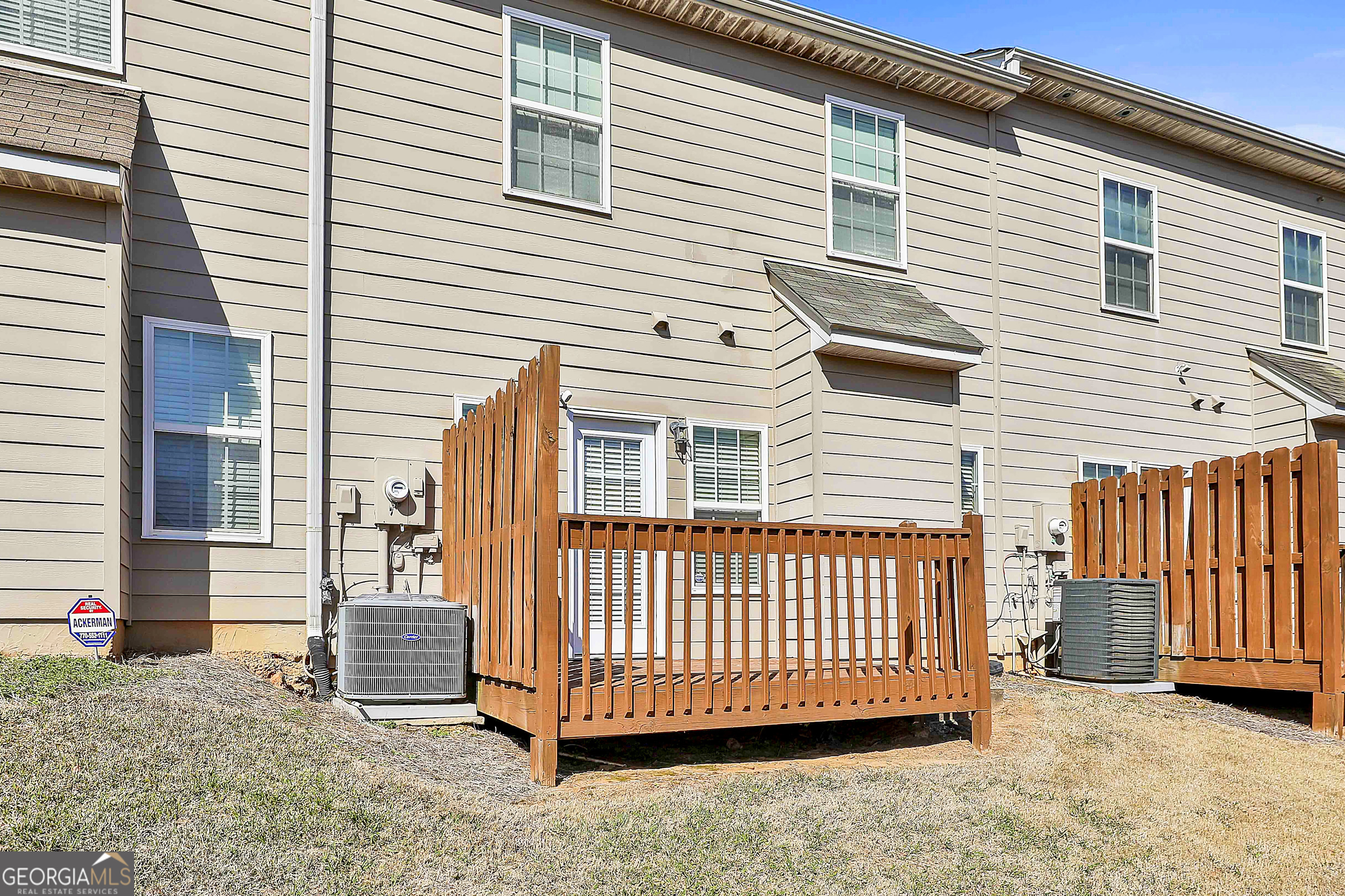 7759 Bucknell Terrace Fairburn, GA 30213 - Photo 22 of 26 a view of a house with a yard and wooden fence