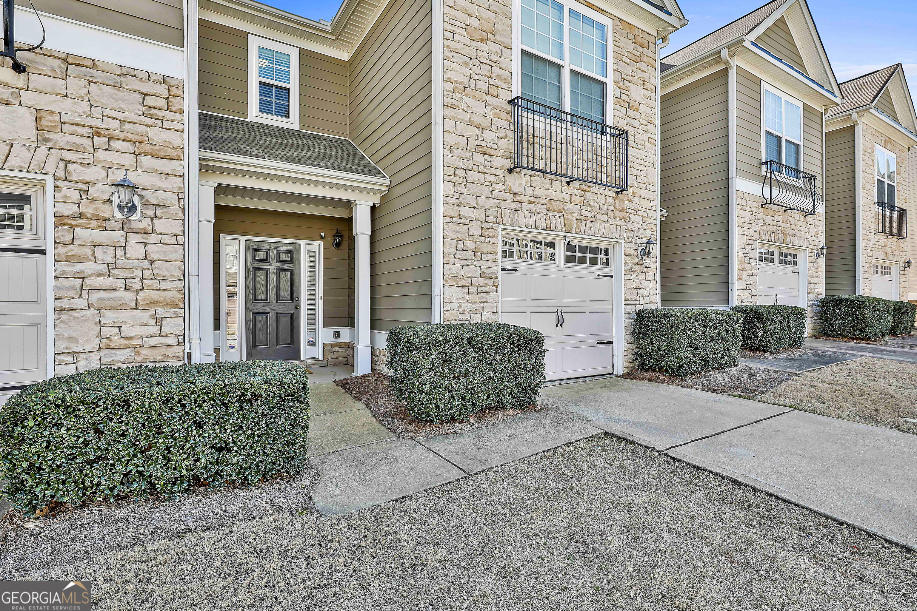 7759 Bucknell Terrace Fairburn, GA 30213 - Photo 3 of 26 a view of a brick house with potted plants