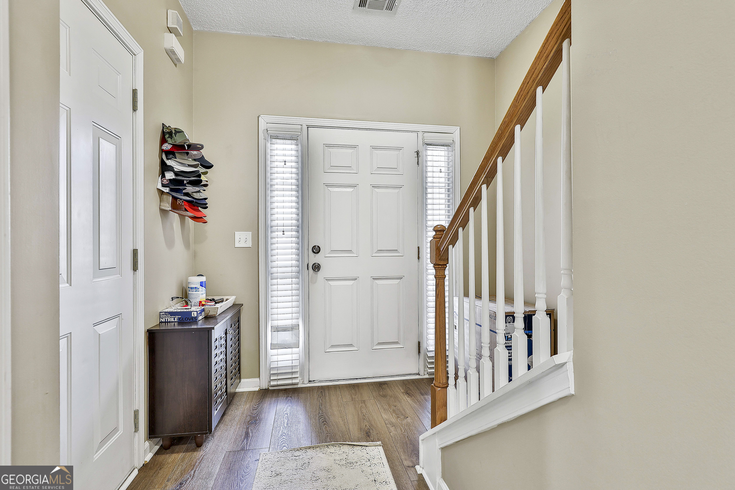7759 Bucknell Terrace Fairburn, GA 30213 - Photo 6 of 26 an entryway with wooden floor and stairs