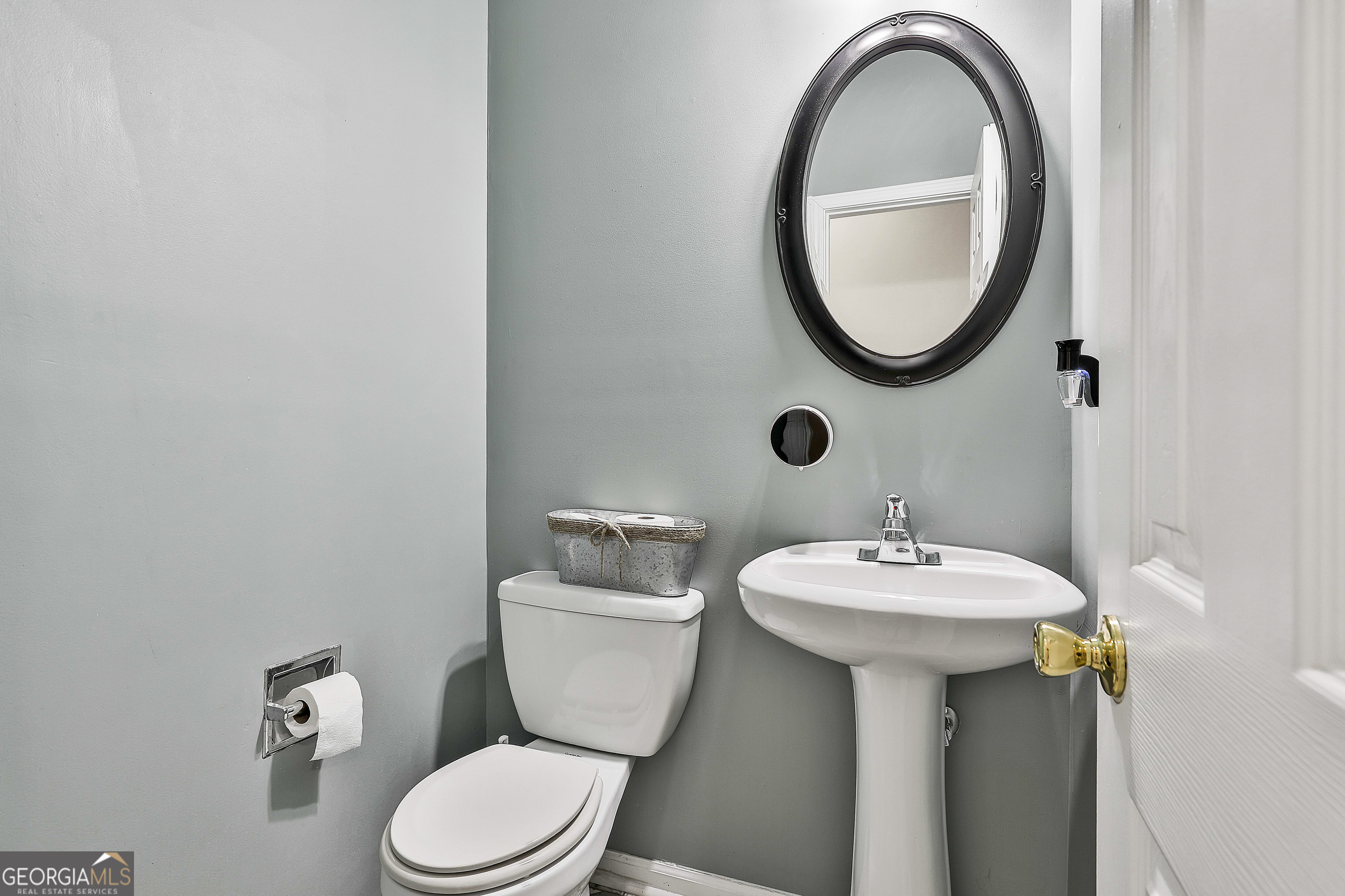 7759 Bucknell Terrace Fairburn, GA 30213 - Photo 7 of 26 a bathroom with a sink and a mirror