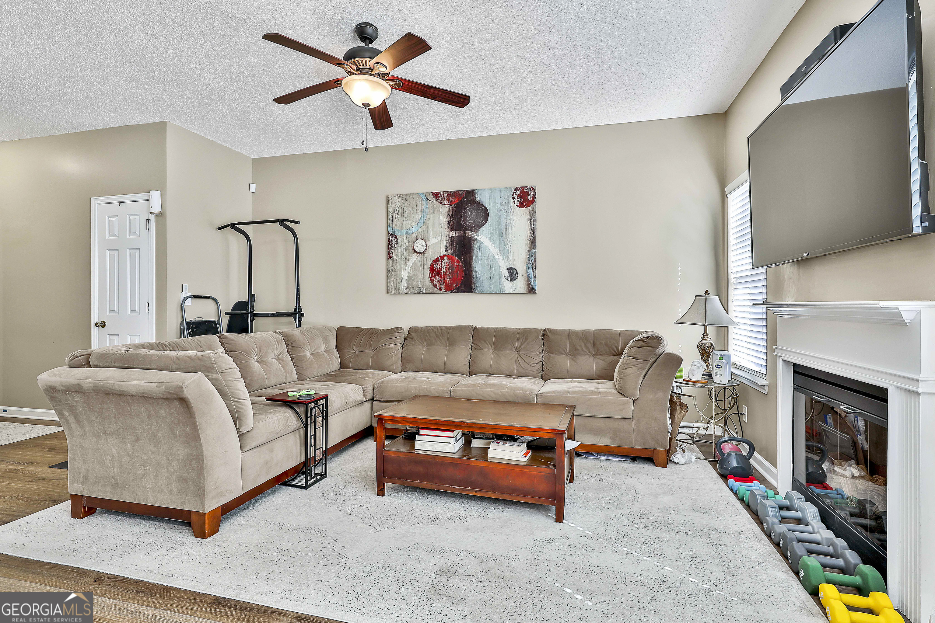7759 Bucknell Terrace Fairburn, GA 30213 - Photo 8 of 26 a living room with furniture and a fireplace
