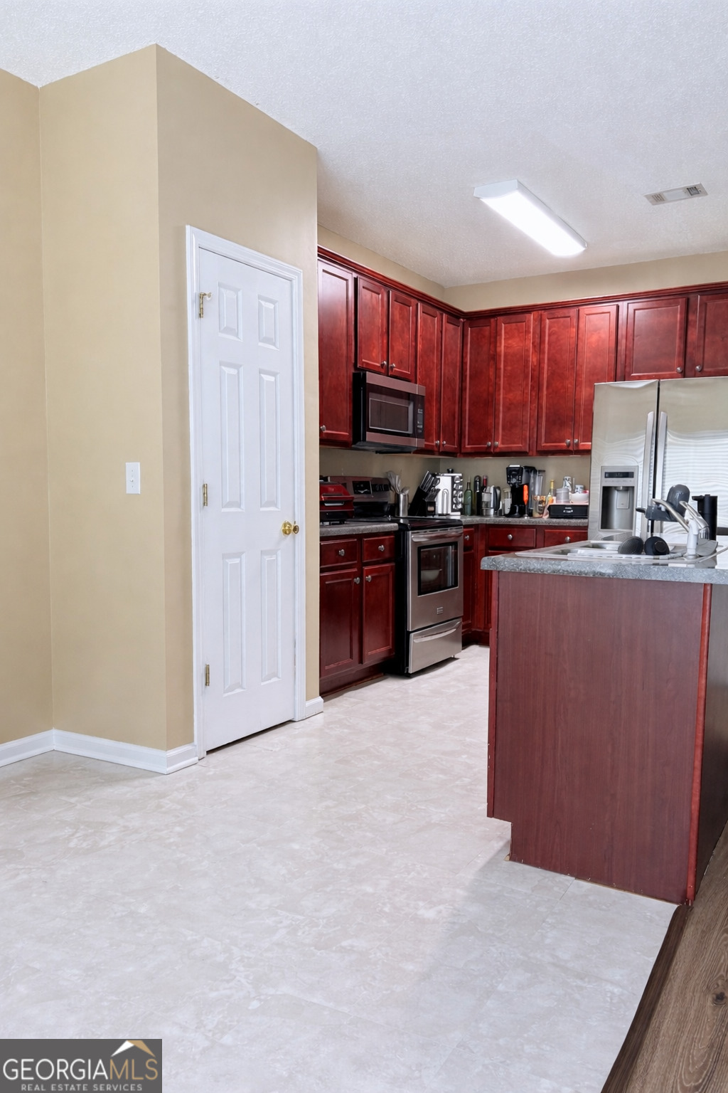 7759 Bucknell Terrace Fairburn, GA 30213 - Photo 10 of 26 a large kitchen with cabinets