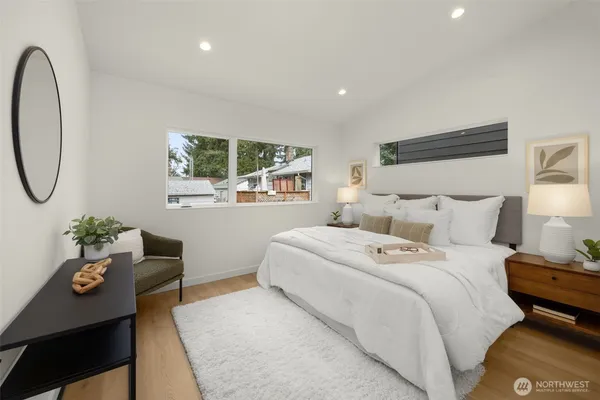 a bedroom with a bed and wooden floor