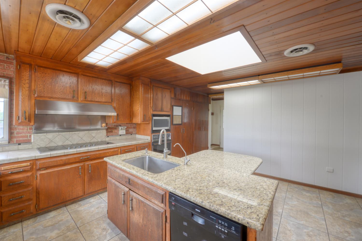 2931 East Marshall Road Patterson, CA 95363 - Photo 11 of 54 TIle and Granite counters, Dishwasher, electric stove top, stove hood, Wall over, Built in Microwave and compactor
