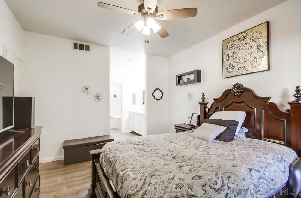 9728 Marilla Drive, Unit 312 Lakeside, CA 92040 - Photo 12 of 28 a bedroom with a bed and a chandelier