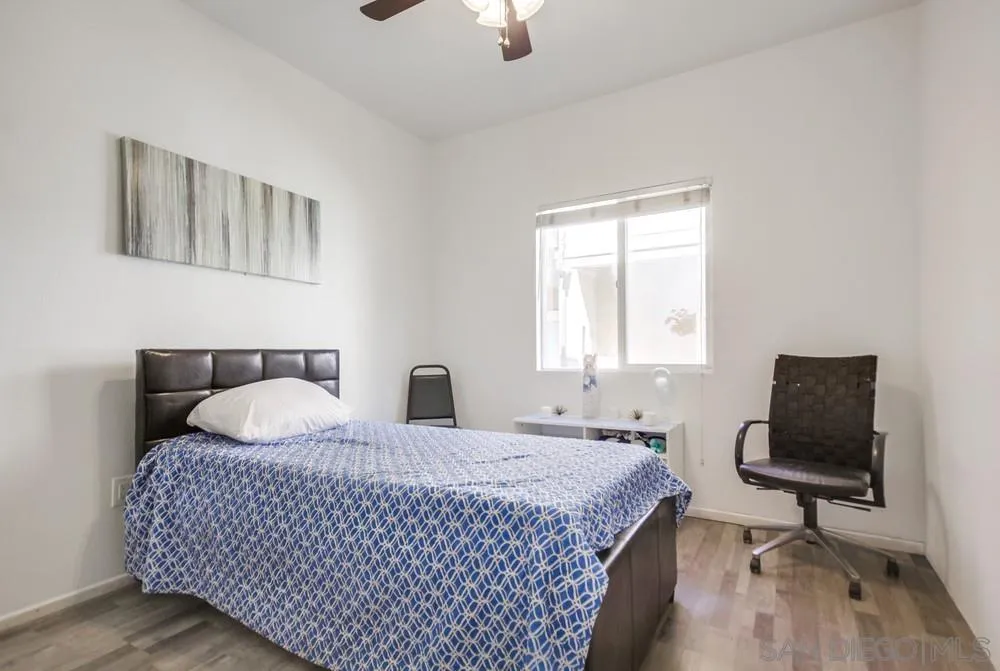 9728 Marilla Drive, Unit 312 Lakeside, CA 92040 - Photo 17 of 28 a bedroom with a bed and wooden floor