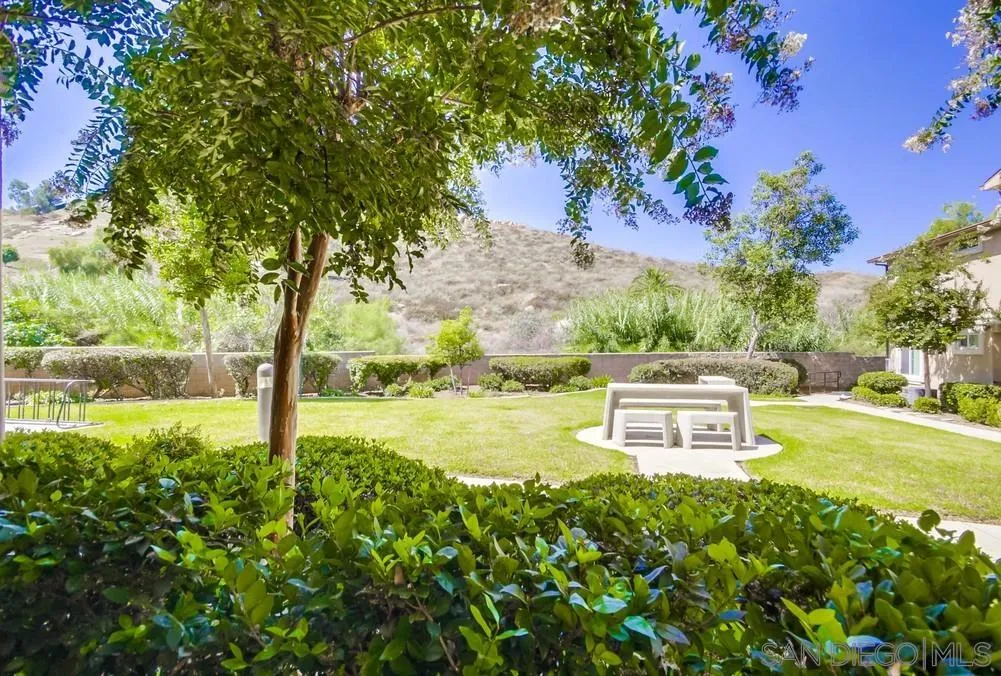 9728 Marilla Drive, Unit 312 Lakeside, CA 92040 - Photo 23 of 28 a backyard of a house with table and chairs