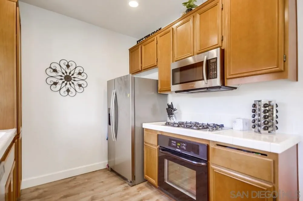 9728 Marilla Drive, Unit 312 Lakeside, CA 92040 - Photo 8 of 28 a kitchen with stainless steel appliances granite countertop a refrigerator stove and microwave