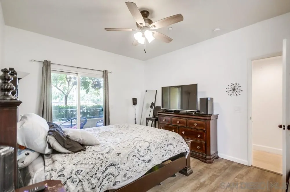 9728 Marilla Drive, Unit 312 Lakeside, CA 92040 - Photo 10 of 28 a bedroom with a large bed and a flat tv screen