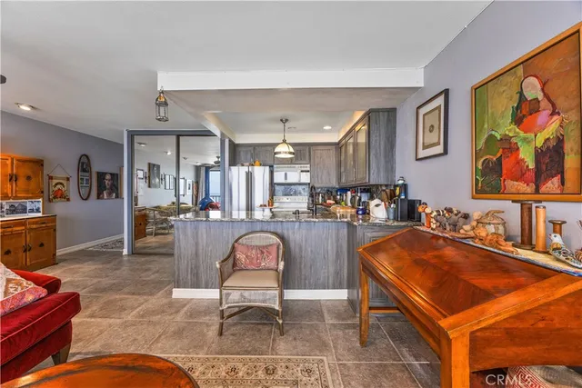 a living room with furniture a counter space and stainless steel appliances