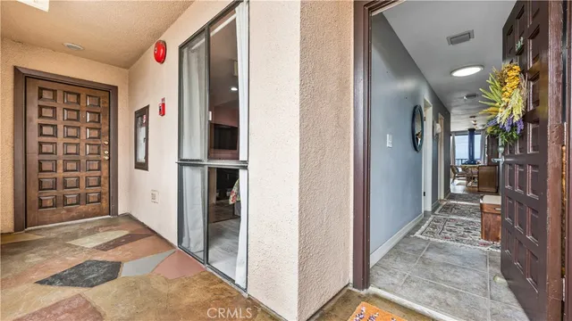 a view of a hallway with closet and a window