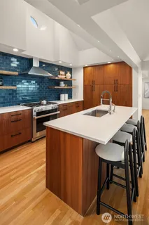 a kitchen with stainless steel appliances granite countertop a stove a sink and a refrigerator