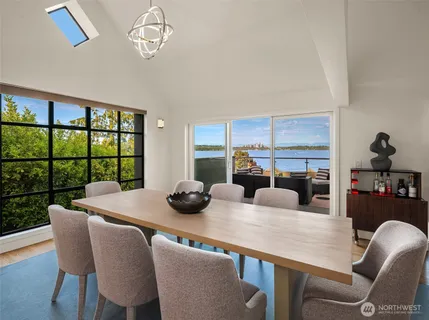 a dining room with furniture a large window and a table