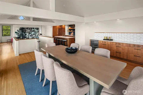 a dining room with furniture and wooden floor