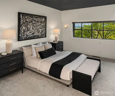 a bedroom with a bed and a wall painting