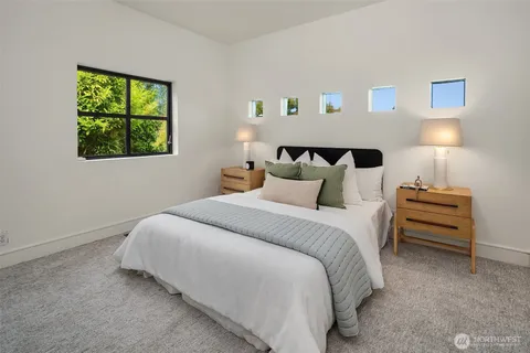 a bedroom with a bed and a painting on the wall